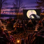 Guests in blankets with hot drinks and patio heaters watching The Nightmare Before Christmas at an outdoor movie night